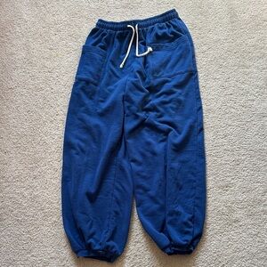 Out from under blue barrel sweatpants